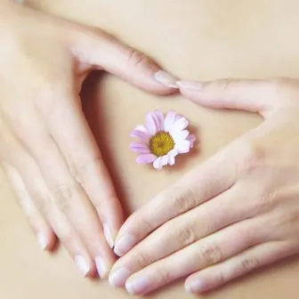Mains en forme de cœur et marguerite